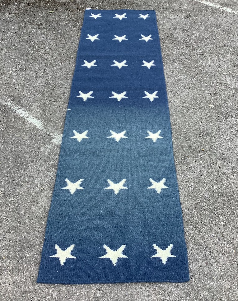 A contemporary wool runner with star motifs, 300 x 76cm